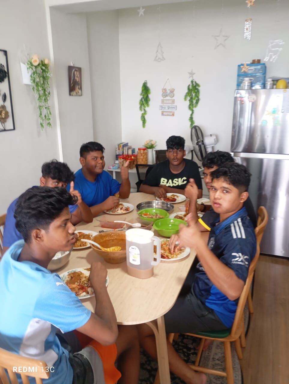 Young people sharing a meal together at the home