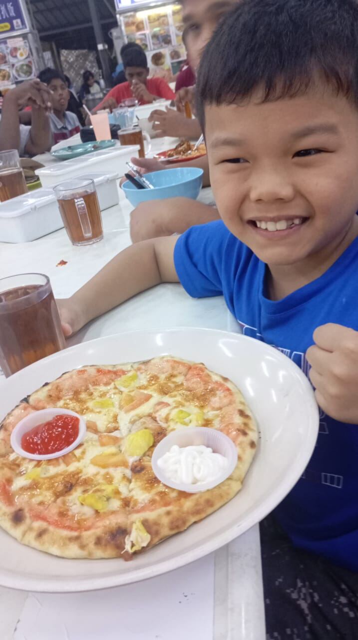 A boy enjoying a meal out with the group