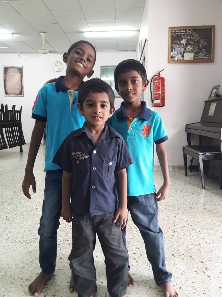 Three boys at the home, smiling