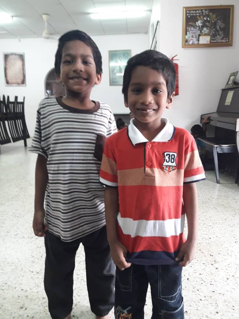 Two boys at Bright Future Home standing together indoors